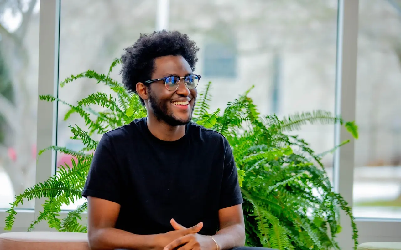 A smiling man talking at a table