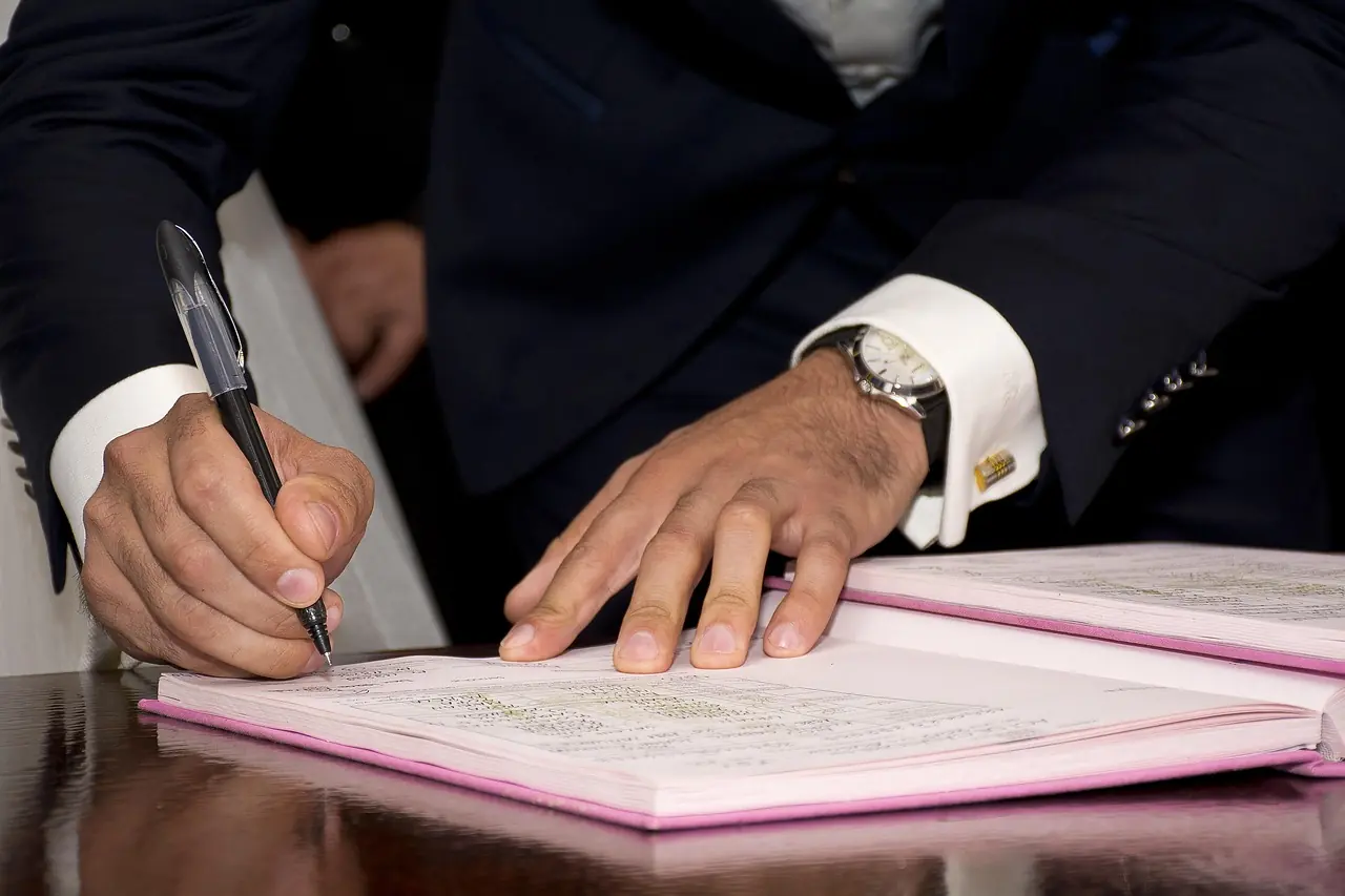 Hands signing land documents