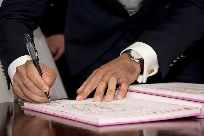 Hands signing land documents